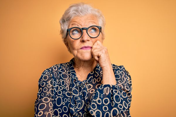 Senior Beautiful Grey-haired Woman Wearing Casual Shirt And Glasses
